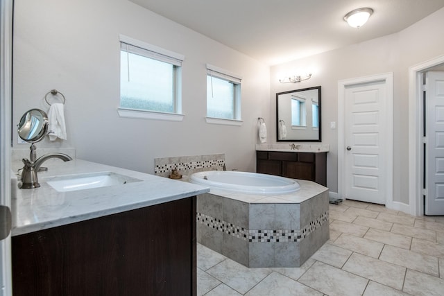 21207 Bradford Grove Dr, Spring, TX 77379 - full bathroom with two vanities, a bath, and tile patterned flooring