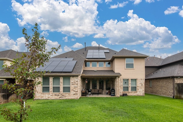 21207 Bradford Grove Dr, Spring, TX 77379 - back of house with a patio area, solar panels, brick siding, a fenced backyard, and a shingled roof