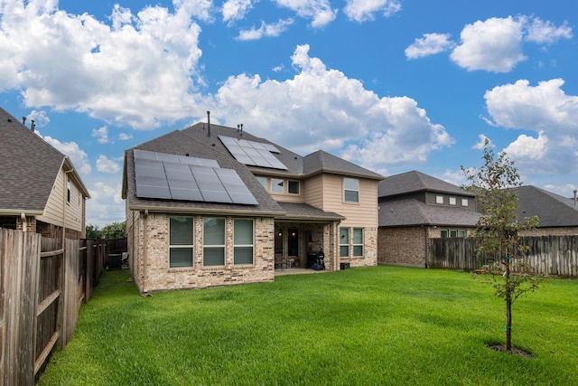 21207 Bradford Grove Dr, Spring, TX 77379 - back of house with brick siding, solar panels, and a fenced backyard