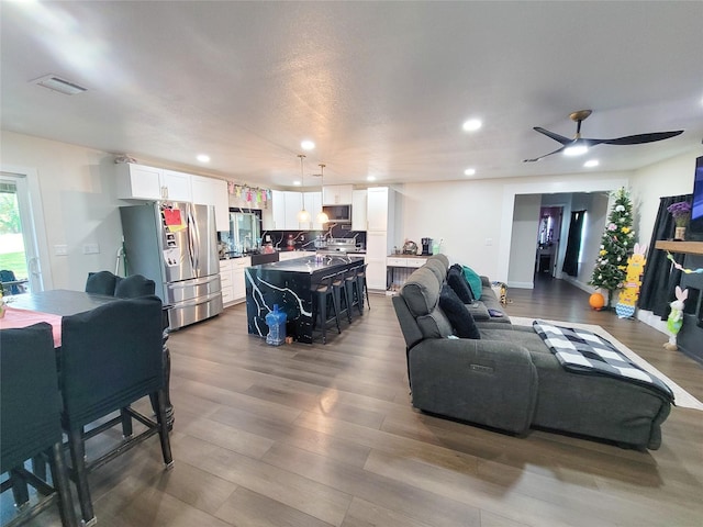 606 E Ahldag St, Wharton, TX 77488 - living room featuring wood finished floors, recessed lighting, and a ceiling fan