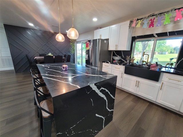 606 E Ahldag St, Wharton, TX 77488 - kitchen with stainless steel fridge with ice dispenser, white cabinetry, dark wood finished floors, and recessed lighting