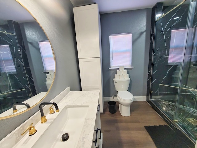 606 E Ahldag St, Wharton, TX 77488 - full bathroom with a marble finish shower, wood finished floors, and vanity