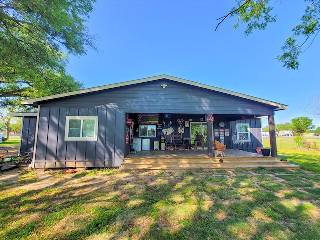 606 E Ahldag St, Wharton, TX 77488 - back of house with board and batten siding, a yard, and a wooden deck
