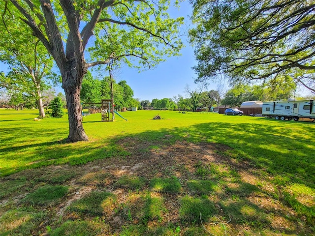 606 E Ahldag St, Wharton, TX 77488 - view of green lawn with a playground