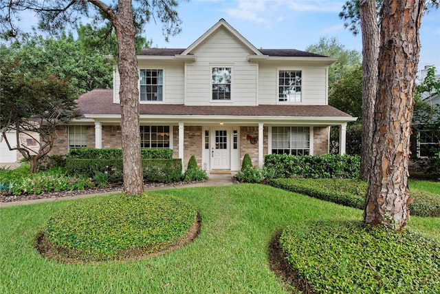 7615 Sandygate Ln, Houston, TX 77095 - traditional-style home featuring a front yard, a shingled roof, and brick siding
