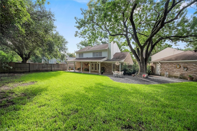 7615 Sandygate Ln, Houston, TX 77095 - rear view of house featuring french doors, a patio area, a fenced backyard, brick siding, and a chimney