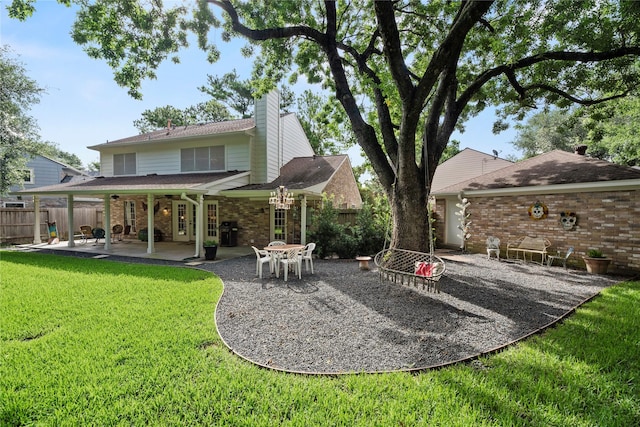 7615 Sandygate Ln, Houston, TX 77095 - back of property with a patio area, a chimney, and brick siding