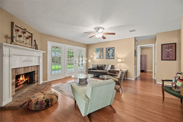 7615 Sandygate Ln, Houston, TX 77095 - living area with ceiling fan, a brick fireplace, wood finished floors, and a textured ceiling