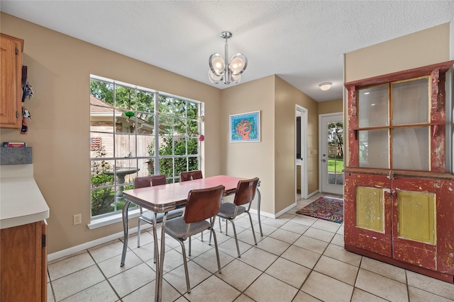7615 Sandygate Ln, Houston, TX 77095 - dining room featuring a chandelier, light tile patterned floors, and a textured ceiling