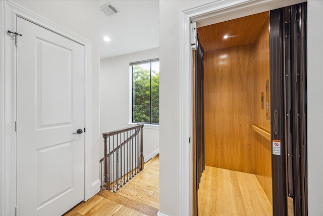 961 Queen Annes Rd, Houston, TX 77024 - hallway featuring wood finished floors, elevator, an upstairs landing, and recessed lighting