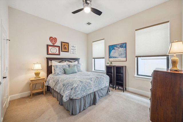 961 Queen Annes Rd, Houston, TX 77024 - bedroom featuring multiple windows, light carpet, and a ceiling fan