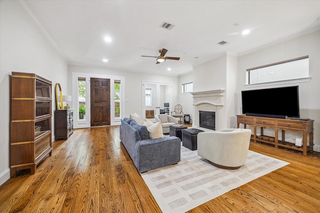961 Queen Annes Rd, Houston, TX 77024 - living area featuring wood finished floors, a glass covered fireplace, crown molding, recessed lighting, and a ceiling fan