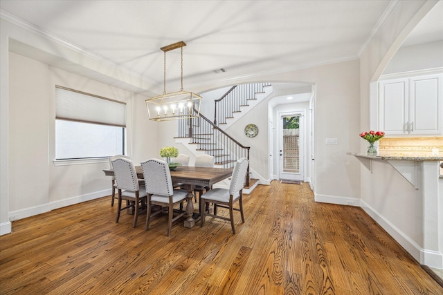 961 Queen Annes Rd, Houston, TX 77024 - dining room with plenty of natural light, stairway, arched walkways, wood finished floors, and ornamental molding