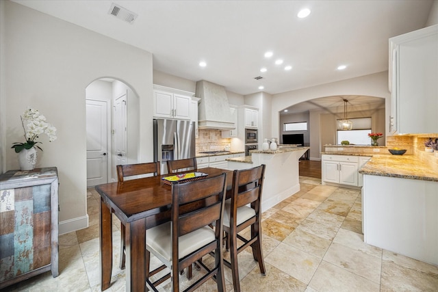 961 Queen Annes Rd, Houston, TX 77024 - dining room with arched walkways and recessed lighting