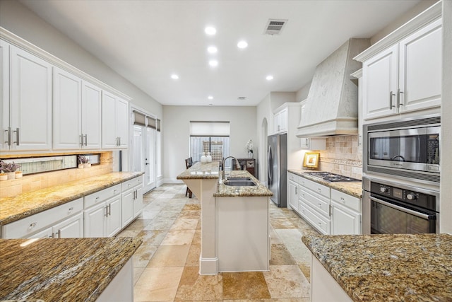 961 Queen Annes Rd, Houston, TX 77024 - kitchen featuring stainless steel appliances, premium range hood, white cabinets, and recessed lighting