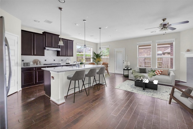 22519 Birch Ridge Meadow Dr, Spring, TX 77389 - kitchen featuring gas cooktop, dark wood finished floors, an island with sink, stainless steel refrigerator, and recessed lighting
