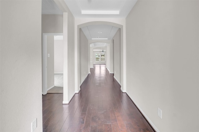 22519 Birch Ridge Meadow Dr, Spring, TX 77389 - corridor featuring a raised ceiling, arched walkways, and dark wood-style floors