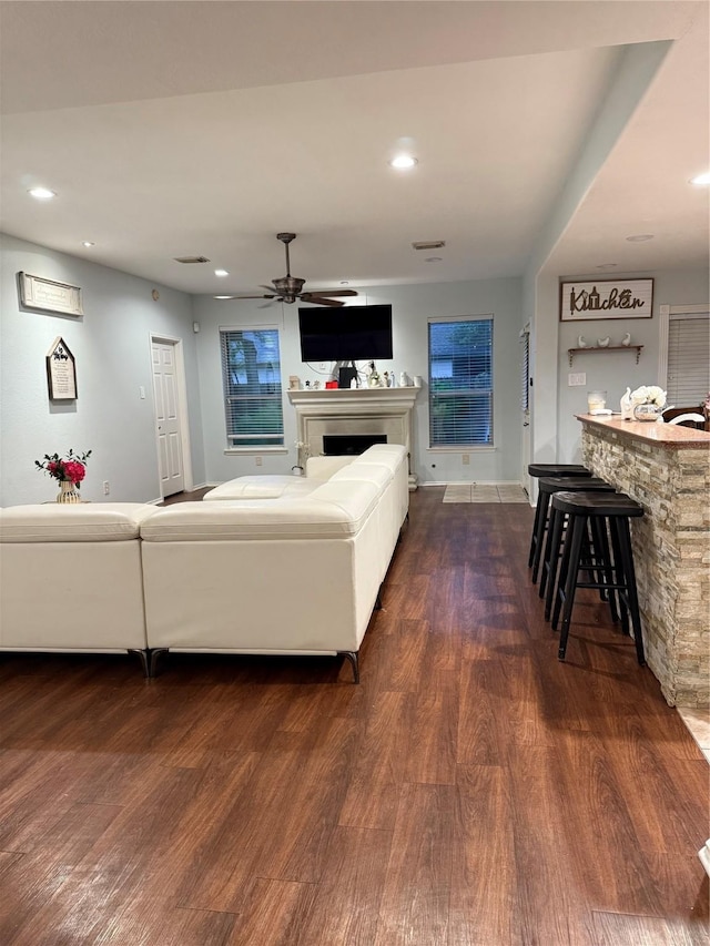 14022 Blackfoot Trail Run, Cypress, TX 77429 - living room with dark wood-type flooring, a fireplace, a ceiling fan, and recessed lighting