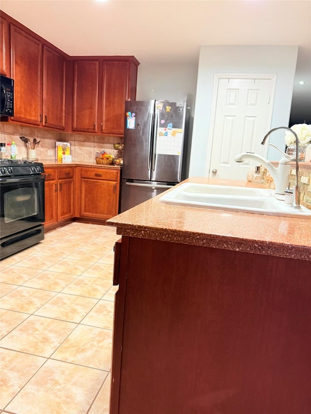 14022 Blackfoot Trail Run, Cypress, TX 77429 - kitchen with black appliances, light tile patterned floors, and backsplash