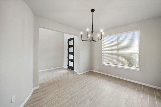 4805 Magnolia Springs Dr, Pearland, TX 77584 - unfurnished room with a chandelier and light wood-style flooring