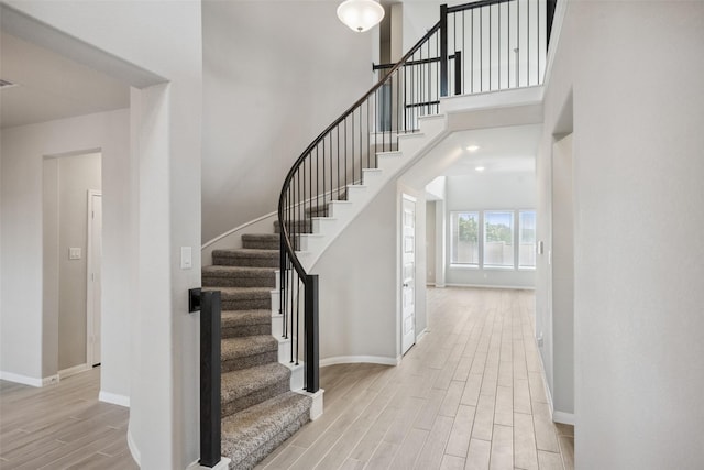 4805 Magnolia Springs Dr, Pearland, TX 77584 - stairway with wood tiled floors and a towering ceiling