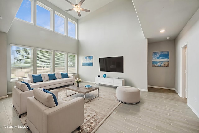 4805 Magnolia Springs Dr, Pearland, TX 77584 - living room featuring a ceiling fan, light wood-type flooring, a high ceiling, and recessed lighting