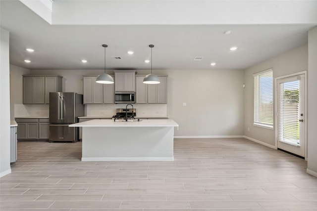 4805 Magnolia Springs Dr, Pearland, TX 77584 - kitchen featuring stainless steel appliances, decorative backsplash, light countertops, gray cabinets, and recessed lighting