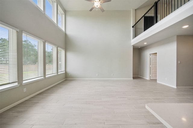 4805 Magnolia Springs Dr, Pearland, TX 77584 - empty room featuring a ceiling fan, a towering ceiling, and light wood finished floors