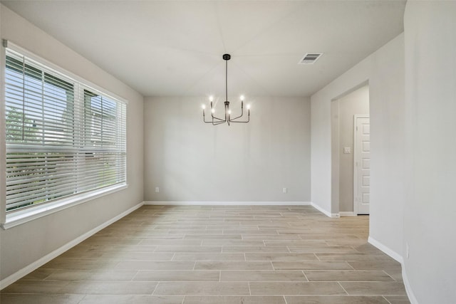 4805 Magnolia Springs Dr, Pearland, TX 77584 - unfurnished room featuring a chandelier and light wood-type flooring