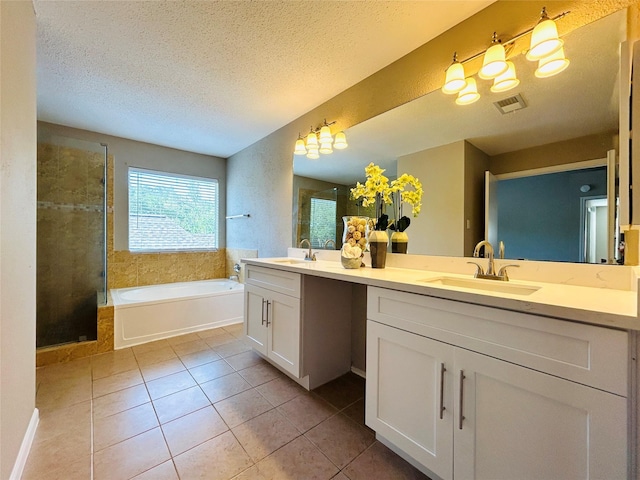 2802 Grants River Cir, Sugar Land, TX 77479 - full bath with double vanity, tile patterned flooring, a garden tub, a stall shower, and a textured ceiling