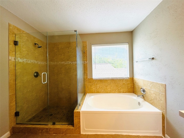 2802 Grants River Cir, Sugar Land, TX 77479 - full bathroom featuring a bath, a shower stall, a textured ceiling, and a textured wall