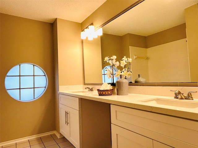2802 Grants River Cir, Sugar Land, TX 77479 - bathroom with double vanity, tile patterned flooring, and a textured ceiling