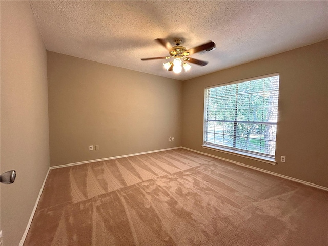 2802 Grants River Cir, Sugar Land, TX 77479 - unfurnished room with light colored carpet, ceiling fan, and a textured ceiling