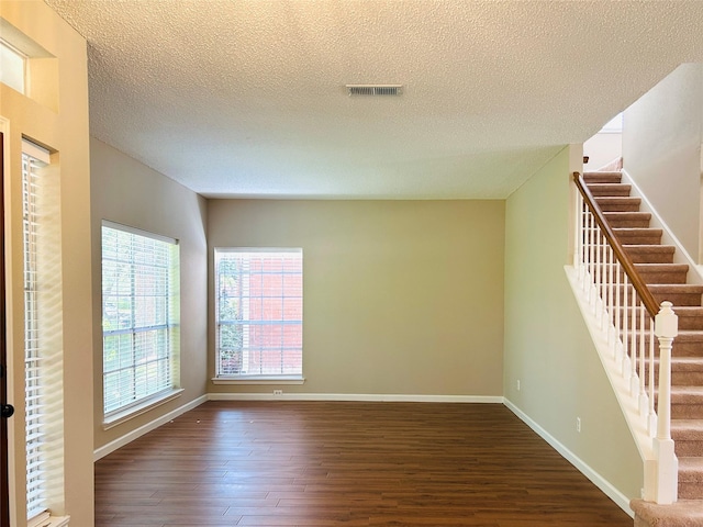 2802 Grants River Cir, Sugar Land, TX 77479 - empty room with dark wood finished floors, stairway, and a textured ceiling