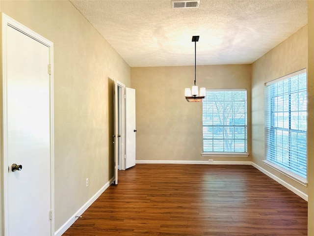 2802 Grants River Cir, Sugar Land, TX 77479 - unfurnished dining area with dark wood-style flooring, a textured ceiling, and a chandelier