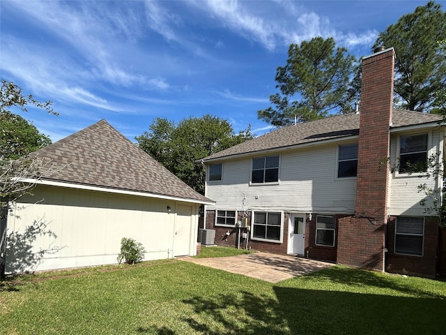 2802 Grants River Cir, Sugar Land, TX 77479 - back of property featuring a chimney, a patio, a yard, brick siding, and roof with shingles