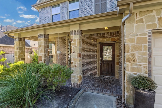 2209 Valley Blossum Ln, League City, TX 77573 - property entrance featuring brick siding, stone siding, and covered porch