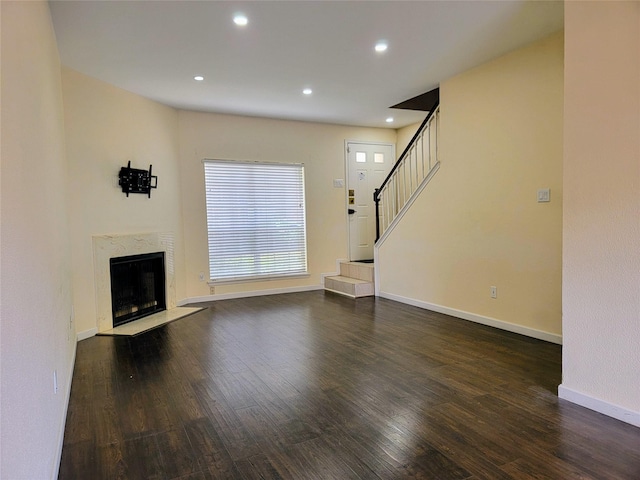 1515 Sandy Springs Rd Unit 1903, Houston, TX 77042 - unfurnished living room with wood finished floors, recessed lighting, a premium fireplace, and stairway