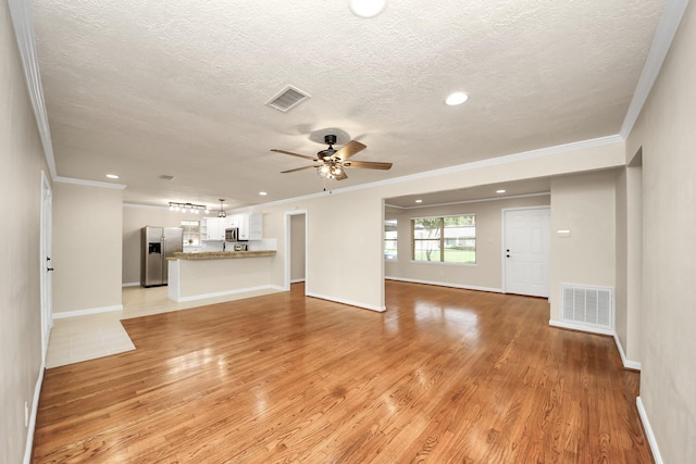 2215 Gardenia Dr, Houston, TX 77018 - unfurnished living room with ornamental molding, a textured ceiling, light wood finished floors, a ceiling fan, and recessed lighting