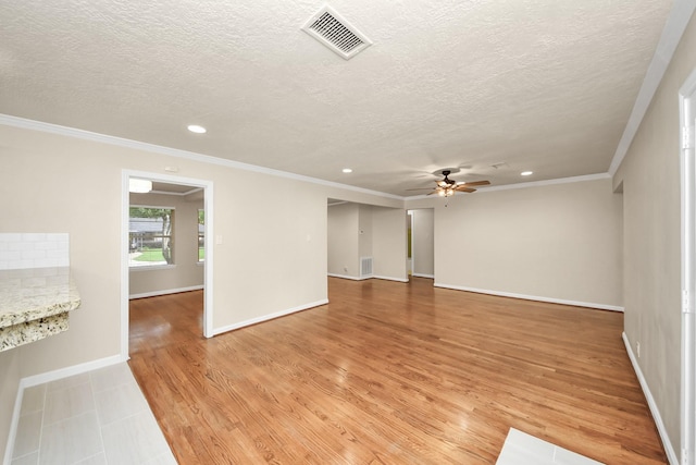 2215 Gardenia Dr, Houston, TX 77018 - spare room featuring crown molding, recessed lighting, a ceiling fan, a textured ceiling, and light wood-type flooring