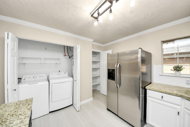 2215 Gardenia Dr, Houston, TX 77018 - washroom featuring washing machine and clothes dryer, crown molding, and a textured ceiling