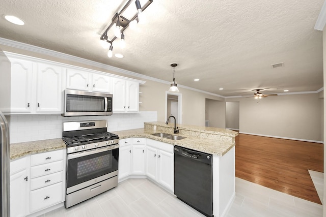 2215 Gardenia Dr, Houston, TX 77018 - kitchen featuring appliances with stainless steel finishes, a peninsula, recessed lighting, white cabinets, and ceiling fan