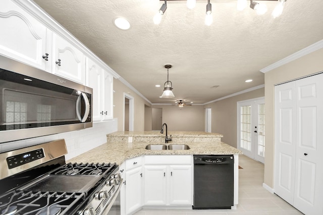 2215 Gardenia Dr, Houston, TX 77018 - kitchen featuring appliances with stainless steel finishes, a peninsula, crown molding, white cabinetry, and ceiling fan