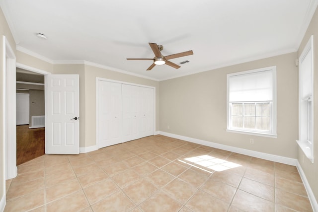 2215 Gardenia Dr, Houston, TX 77018 - unfurnished bedroom with light tile patterned floors, a closet, crown molding, and a ceiling fan
