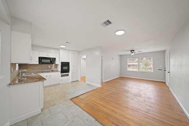 2931 Barksdale Dr, Houston, TX 77093 - kitchen with black appliances, a ceiling fan, decorative backsplash, white cabinets, and open floor plan