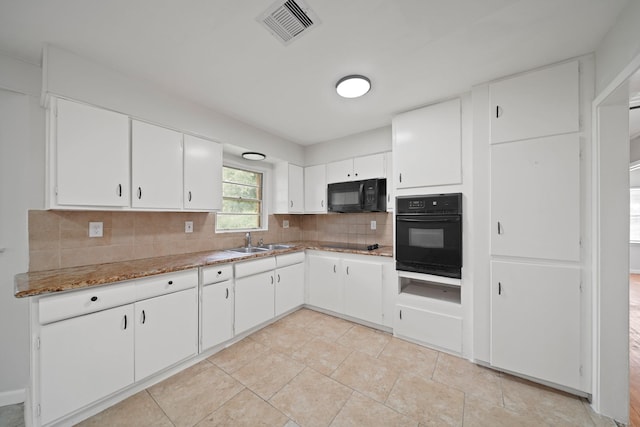 2931 Barksdale Dr, Houston, TX 77093 - kitchen featuring black appliances, tasteful backsplash, white cabinetry, and light stone countertops