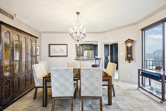 3350 Mccue Rd Unit 1504, Houston, TX 77056 - dining space featuring a chandelier, a textured ceiling, and crown molding