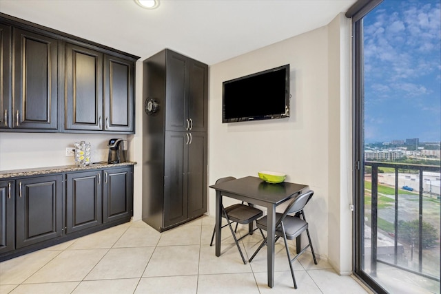 3350 Mccue Rd Unit 1504, Houston, TX 77056 - kitchen with light tile patterned floors and light stone countertops