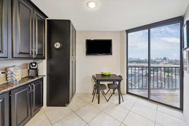 3350 Mccue Rd Unit 1504, Houston, TX 77056 - kitchen with plenty of natural light, dark stone countertops, expansive windows, and light tile patterned flooring