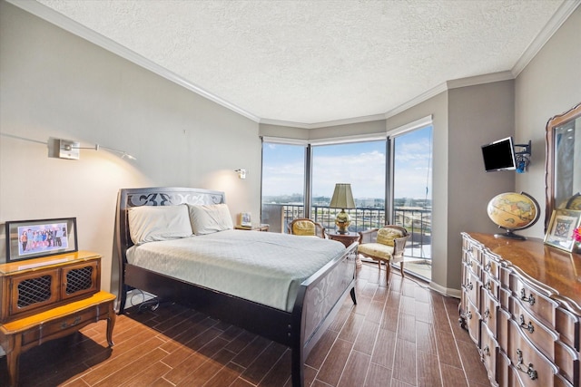 3350 Mccue Rd Unit 1504, Houston, TX 77056 - bedroom with access to exterior, dark wood-style floors, a textured ceiling, and ornamental molding
